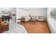 Bright living room featuring hardwood floors and neutral decor, seamlessly connected to the adjacent dining area at 4581 21St N Ave, St Petersburg, FL 33713
