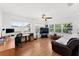Bright living room features wood floors, a ceiling fan, and multiple windows at 4581 21St N Ave, St Petersburg, FL 33713