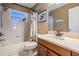 Bathroom featuring a shower-tub combo, neutral color palette, and framed mirror at 4613 Portobello Cir, Valrico, FL 33596