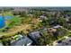 Aerial view of properties on a golf course, showcasing private pools and mature landscaping at 4617 Cloverlawn Dr, Tampa, FL 33624