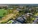Aerial view of houses with golf course views and private pools surrounded by trees and green space at 4617 Cloverlawn Dr, Tampa, FL 33624