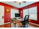 Bedroom with red walls, wood floors, and white trim at 4617 Cloverlawn Dr, Tampa, FL 33624