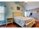 Bright bedroom featuring a vaulted ceiling, light blue walls, and hardwood floors at 4617 Cloverlawn Dr, Tampa, FL 33624