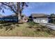 Inviting single-story home with well-maintained lawn, mature trees, red front door, and attached garage at 4617 Cloverlawn Dr, Tampa, FL 33624