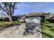 Welcoming single-story home with a paved driveway leading to the attached garage and vibrant green lawn at 4617 Cloverlawn Dr, Tampa, FL 33624