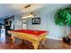 Well-lit game room features a beautiful billiard table and wood laminate flooring at 4617 Cloverlawn Dr, Tampa, FL 33624