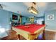 Bright game room with a billiard table, overhead light fixture, and wood laminate flooring at 4617 Cloverlawn Dr, Tampa, FL 33624