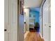 Hallway that leads to a bedroom, featuring wood floors and white doors on either side at 4617 Cloverlawn Dr, Tampa, FL 33624