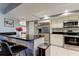 Kitchen with bar stool seating at the island and stainless steel appliances at 4617 Cloverlawn Dr, Tampa, FL 33624