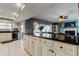 Modern kitchen with large granite island, white cabinets and open view to the living room at 4617 Cloverlawn Dr, Tampa, FL 33624