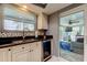 The kitchen area with an updated stainless steel beverage cooler connects to the Florida room at 4617 Cloverlawn Dr, Tampa, FL 33624