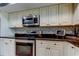 This well-lit kitchen features stainless steel appliances, mosaic backsplash and plenty of cabinet space at 4617 Cloverlawn Dr, Tampa, FL 33624