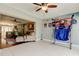 Open living room with ceiling fan, neutral paint, and view into connecting Gathering room at 4617 Cloverlawn Dr, Tampa, FL 33624