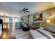 Spacious living room with hardwood floors, comfortable seating, ceiling fan, and ample natural light at 4617 Cloverlawn Dr, Tampa, FL 33624