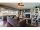 Living room with fireplace, hardwood floors, ceiling fan and Florida room access at 4617 Cloverlawn Dr, Tampa, FL 33624