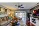 Inviting living room with hardwood floors, comfortable seating, ceiling fan, and a view to the lanai at 4617 Cloverlawn Dr, Tampa, FL 33624