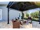 Covered patio features comfortable wicker seating, a gas fire pit, and a tranquil outdoor space at 4617 Cloverlawn Dr, Tampa, FL 33624