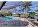 The pool, enclosed by screens, includes lounge chairs for relaxing at 4617 Cloverlawn Dr, Tampa, FL 33624