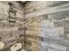 Tiled shower stall showcases gray and white wood-look tiling and multi-toned accent border at 470 Sunset N Rd, Rotonda West, FL 33947