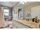 Bathroom with granite countertop vanity, mirror, and tiled shower and tub at 470 Sunset N Rd, Rotonda West, FL 33947
