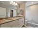 Bathroom featuring a double vanity with granite countertops and tile flooring at 470 Sunset N Rd, Rotonda West, FL 33947