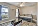 This bedroom features wood-look tile flooring, large windows, and a modern ceiling fan at 470 Sunset N Rd, Rotonda West, FL 33947