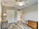 Bedroom featuring ceiling fan, closet, wood look floors and adjacent bathroom at 470 Sunset N Rd, Rotonda West, FL 33947