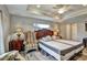 This bedroom features tray ceilings, wood-look tile flooring, and a large window with natural light at 470 Sunset N Rd, Rotonda West, FL 33947