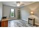 Spacious bedroom features wood-look tile flooring, ceiling fan, and a window at 470 Sunset N Rd, Rotonda West, FL 33947