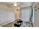 This bedroom features wood-look tile flooring, a closet, and a modern ceiling fan at 470 Sunset N Rd, Rotonda West, FL 33947