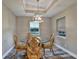 Cozy dining area features a glass table with ornate chairs and elegant pendant lighting at 470 Sunset N Rd, Rotonda West, FL 33947