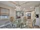 Dining area with a modern light fixture, large windows, and wood-look tile flooring at 470 Sunset N Rd, Rotonda West, FL 33947
