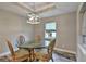 This dining area features a glass table, ornate chairs, and a modern light fixture at 470 Sunset N Rd, Rotonda West, FL 33947