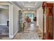 Open-concept entryway with wood-look tile, tray ceiling, and elegant decor leading to the living area at 470 Sunset N Rd, Rotonda West, FL 33947
