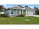 Charming single-story home with lush green lawn and well-maintained landscaping at 470 Sunset N Rd, Rotonda West, FL 33947