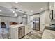 Modern kitchen featuring stainless steel appliances, white cabinets, marble counters, and wood-look tile flooring at 470 Sunset N Rd, Rotonda West, FL 33947