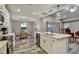 Open kitchen featuring a large marble island, stainless steel appliances, and modern pendant lighting at 470 Sunset N Rd, Rotonda West, FL 33947