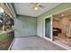 Screened lanai/patio featuring a ceiling fan and view to interior living room at 470 Sunset N Rd, Rotonda West, FL 33947