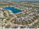 Aerial view of a suburban neighborhood with houses surrounding a lake at 4710 69Th E Ct, Palmetto, FL 34221