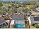 Aerial view of a backyard with a screened in pool and wooden fence at 4710 69Th E Ct, Palmetto, FL 34221