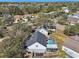 Aerial view of a home featuring a screened in pool surrounded by a wooden fence at 4710 69Th E Ct, Palmetto, FL 34221