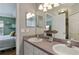 Dual sink bathroom with framed mirror and white cabinets with views of the bedroom at 4710 69Th E Ct, Palmetto, FL 34221