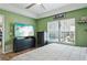 Light-filled bedroom with a ceiling fan and views of the backyard pool at 4710 69Th E Ct, Palmetto, FL 34221