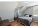Cozy bedroom featuring vaulted ceilings, wood floors, a ceiling fan, and natural light from a large window at 4710 69Th E Ct, Palmetto, FL 34221
