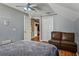Vaulted ceiling bedroom with a ceiling fan and a comfortable seating area at 4710 69Th E Ct, Palmetto, FL 34221