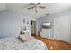 Bedroom with gray walls, hardwood floors, white dresser and walk-in closet at 4710 69Th E Ct, Palmetto, FL 34221