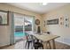 Charming dining area with access to the pool, featuring wood-look floors at 4710 69Th E Ct, Palmetto, FL 34221