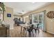 Dining area open to kitchen with view of the pool and backyard, and wood-look floors at 4710 69Th E Ct, Palmetto, FL 34221