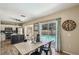 Dining area open to kitchen with view of the pool, wood-look floors, and backyard at 4710 69Th E Ct, Palmetto, FL 34221