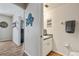 Hallway leading to bathroom with wood-look floors and access to the rooms at 4710 69Th E Ct, Palmetto, FL 34221